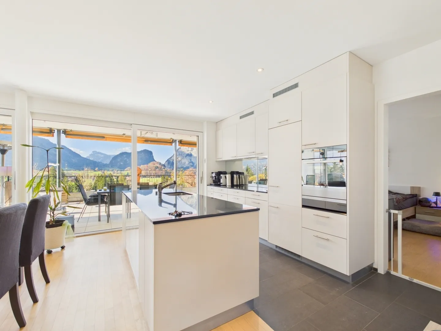 Huge panoramic terrace with mountain view, designer kitchen with cooking island, parking garage with e-charging station & outdoor parking! - Photo 2 of 11