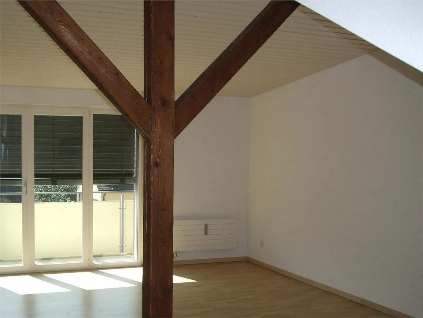 Modern, bright penthouse apartment with south-facing balcony, visible beams, open kitchen - Photo 1 of 7