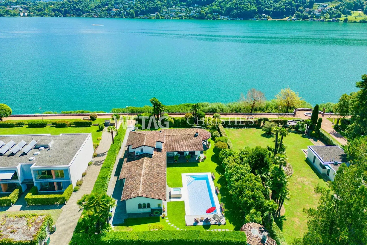 Elegant villa with pool in Lugano-Magliaso for sale, located directly on Lake Lugano - Photo 1 of 13