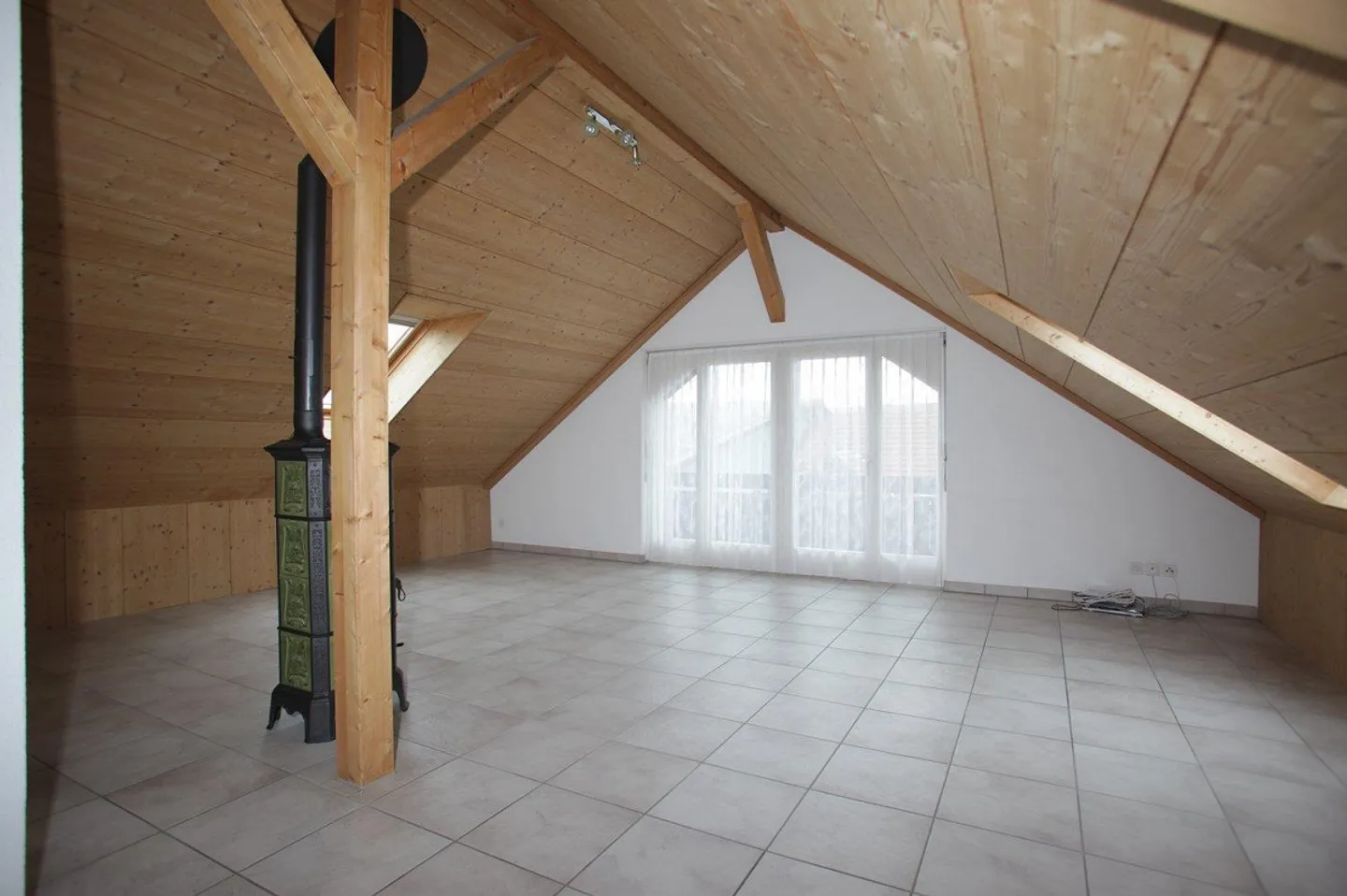 1.5-Room Attic Apartment with Fireplace and Stunning Mountain View - Photo 2 of 7