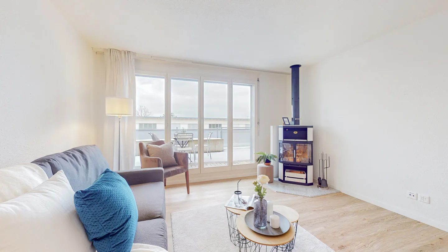 BRIGHT LIVING AREA WITH SWEDISH STOVE - PENTHOUSE IN BAAR - Photo 2 of 5